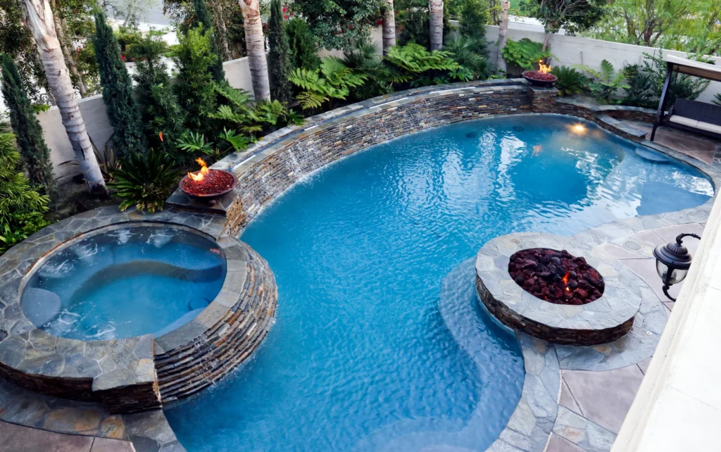 backyard with a kidney shaped or freeform pool with a hot tub spa at the top 