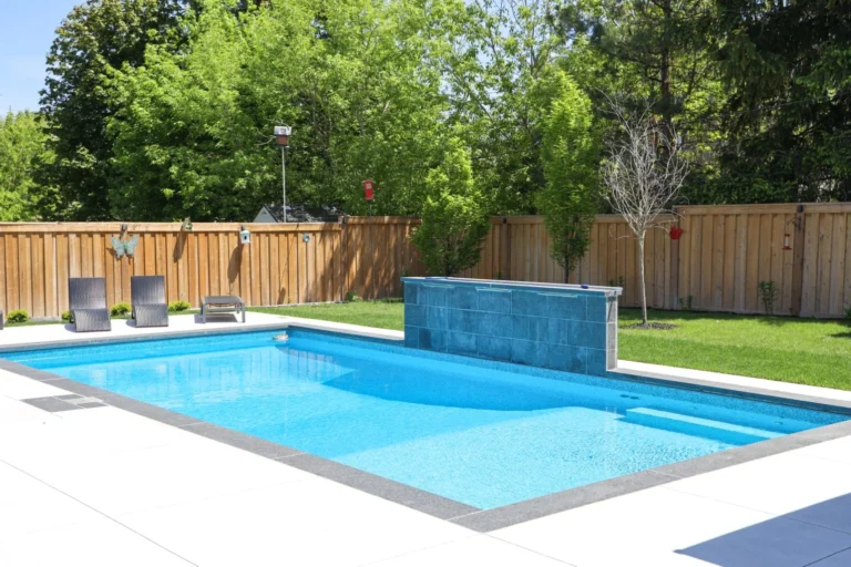 Hardtop gazebo with lounge seating set on a porcelain pool deck beside the pool
